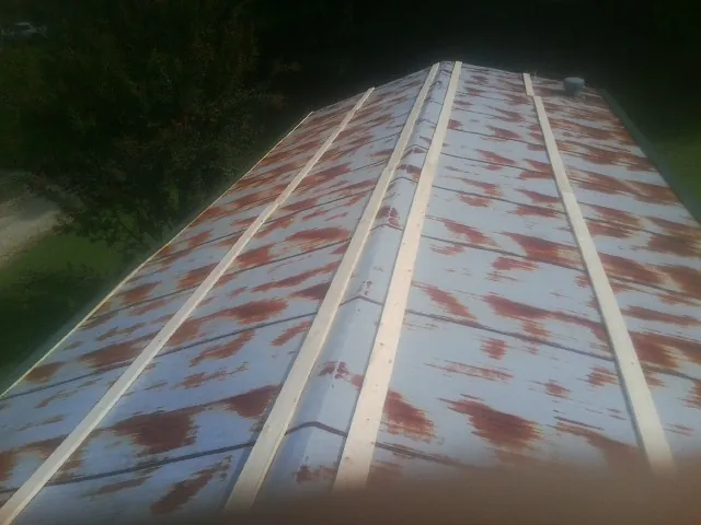Rusted metal roof panels with new wood purlins before replacement — Storm Damage Roof Repair in Newburgh by Roofing Brothers