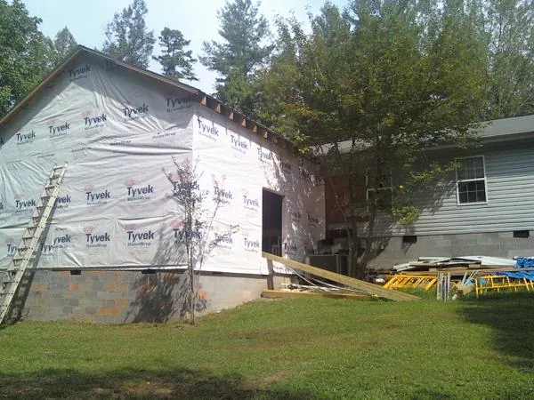 Tyvek wrapped gable on a new room addition beside an existing home in Newburgh