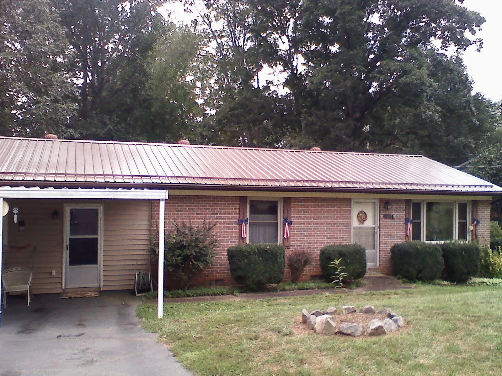 Bronze metal roof and carport on a brick ranch home — Roof Repair work by our crew in Newburgh